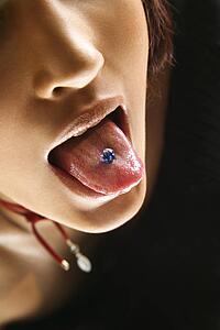 Woman sticking out pierced tongue