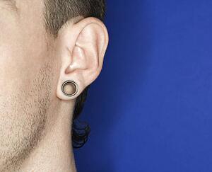 Young adult male pierced ear