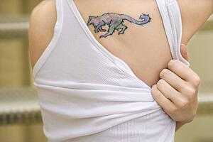 Portrait of young woman with tattoo on shoulder