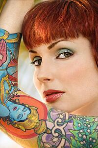 Close up portrait of attractive tattooed woman 