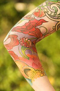 Close up of floral tattoo on arm of Caucasian woman.