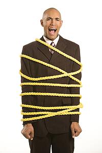 Upset Businessman Tied Up in Rope