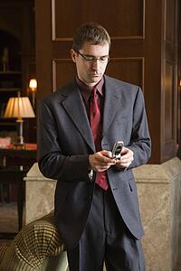 Businessman looking down and his cellphone