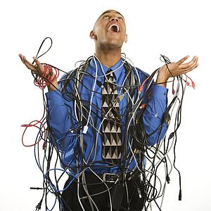 Excited businessman tangled in cables