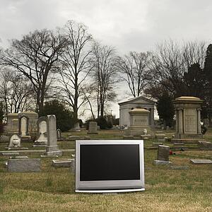 Flat panel television set in cemetery