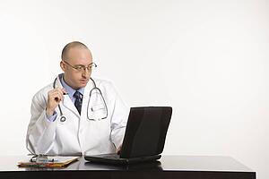 Doctor looking at a laptop computer