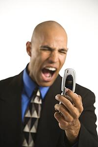 Man in suit yelling at cellphone