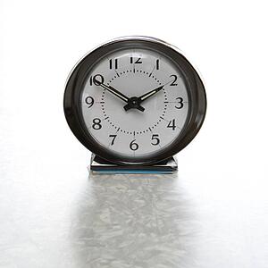 Still life of round vintage alarm clock on table