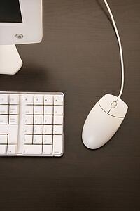Still life of computer monitor, keyboard and mouse.