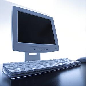 Still life of computer monitor, keyboard and mouse.