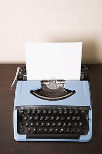 Still life of blank sheet of paper in an old fashioned typewriter