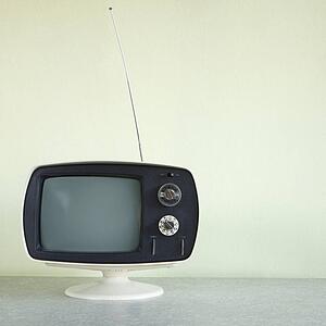 Still life of vintage television set with antenna raised.