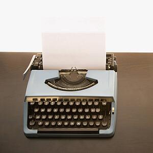 Still life of blank sheet of paper in an old fashioned typewriter