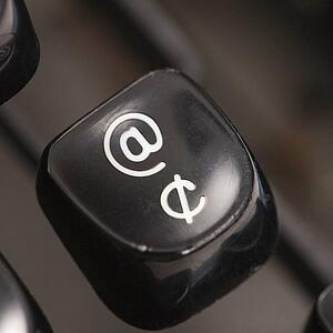 Close up of at sign type lever on typewriter.