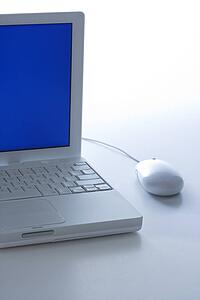 Laptop computer with blue screen and mouse.