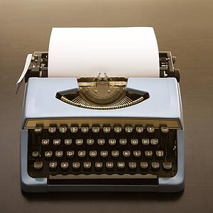 Still life of blank sheet of paper in an old fashioned typewriter