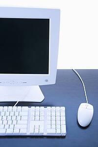 Still life of computer monitor, keyboard and mouse.
