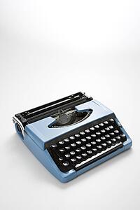 Vintage blue typewriter on white background