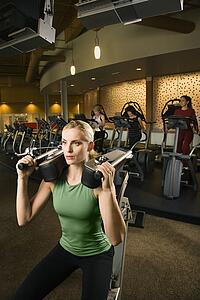 Female using exercise equipment at gym