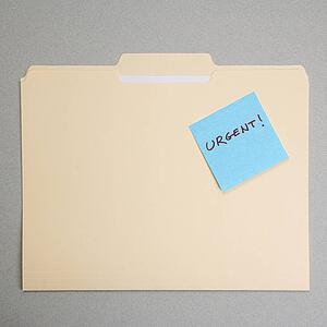 Folder with a sticky note attached reading urgent