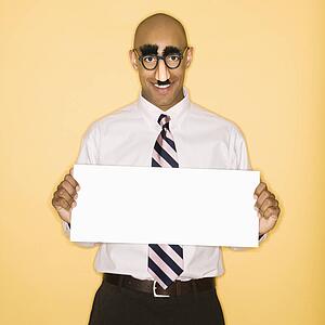 Man wearing groucho mask disguise holding blank sign