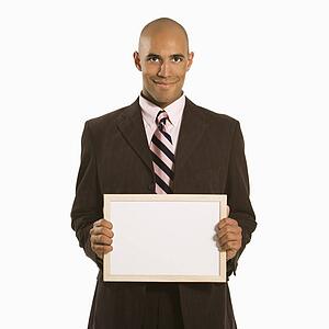 Man holding blank sign standing against white background