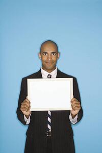 Man holding blank sign against blue background