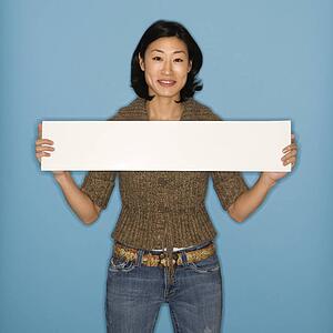 Woman holding blank sign on blue background