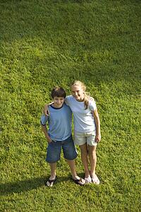 Standing on lawn with arms around each other