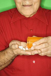 Emptying pill bottle into hand