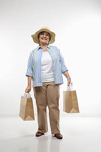 Woman holding gift bags smiling