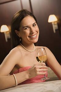 Woman in dress holding glass of wine