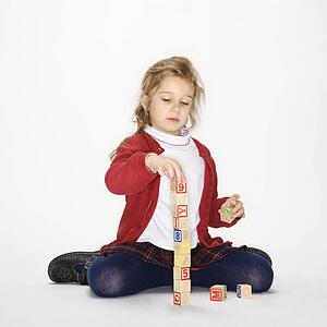 Girl playing with toy blocks 