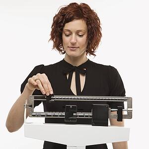 Woman reading her weight on scale