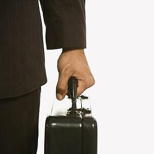 African American businessman in suit holding briefcase.