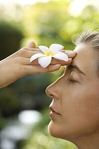 Woman holding plumeria flower