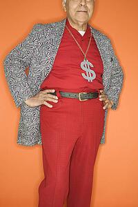 Mature adult Caucasian male wearing money sign necklace.