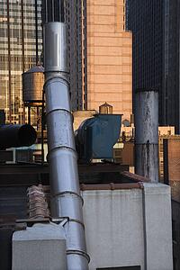 Image of New York City rooftop with vent and duct system.