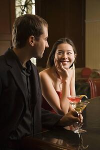Woman and man standing at bar