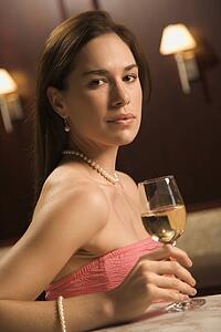 Woman sitting at bar with wine 