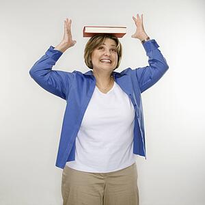 Woman balancing book on head