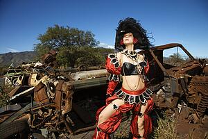 Female dressed in pirate costume in junkyard