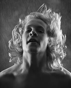 Teen boy flipping hair back.