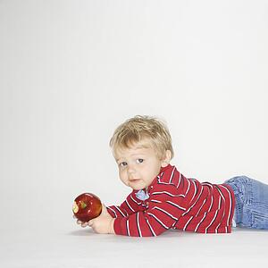 Boy holding apple 