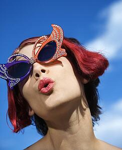Close up of young adult Caucasian female wearing unique vintage glasses.