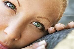 Close-up of young Caucasian woman's face looking at viewer.