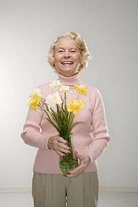 Woman holding bouquet and smiling