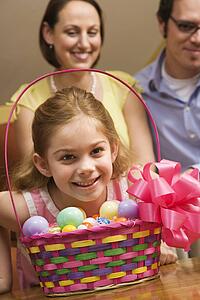 Caucasian family with girl and Easter basket. 