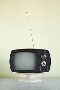 Still life of vintage television set with antenna raised.