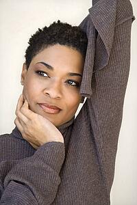 Close up of African- American woman with head on hand.